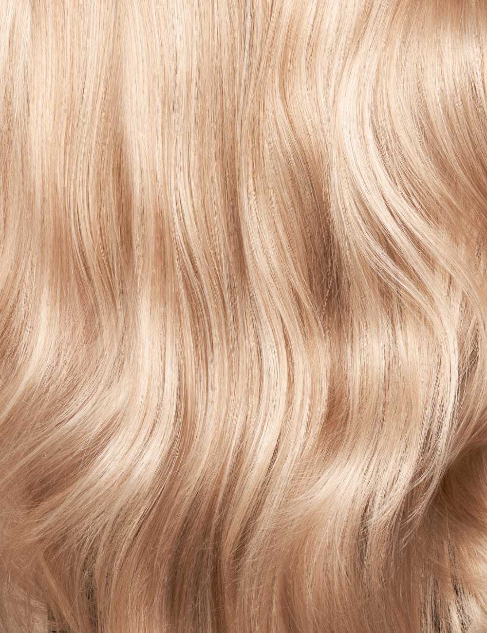 Wavy blonde hair texture, close-up detail of soft, smooth, flowing strands.